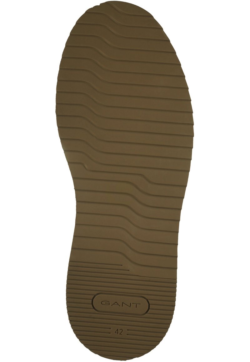 Semelle en caoutchouc marron avec un motif ondulé texturé, comportant un logo "GANT" et la taille "42" embossés sur la surface.