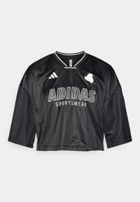 Černý zkrácený sportovní dres vyrobený z hladkého materiálu s krátkými rukávy. Obsahuje bílé logo "ADIDAS" a design s pruhovaným výstřihem.