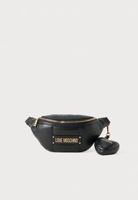 Juodas odinis fanny pack'as su auksiniu logotipo pleistru ir detalėmis. Turi užtrauktuko uždarymą ir prijungtą mažą krepšį, atitinkančiu dizainą.