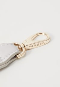 Bracciale in pelle grigia Valentino con una clip metallica dorata lucida. L'hardware presenta un marchio inciso e una superficie liscia.
