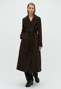 Long brown wool coat with a belted waist, wide lapels, and buttoned cuffs. Features a streamlined silhouette and soft texture.