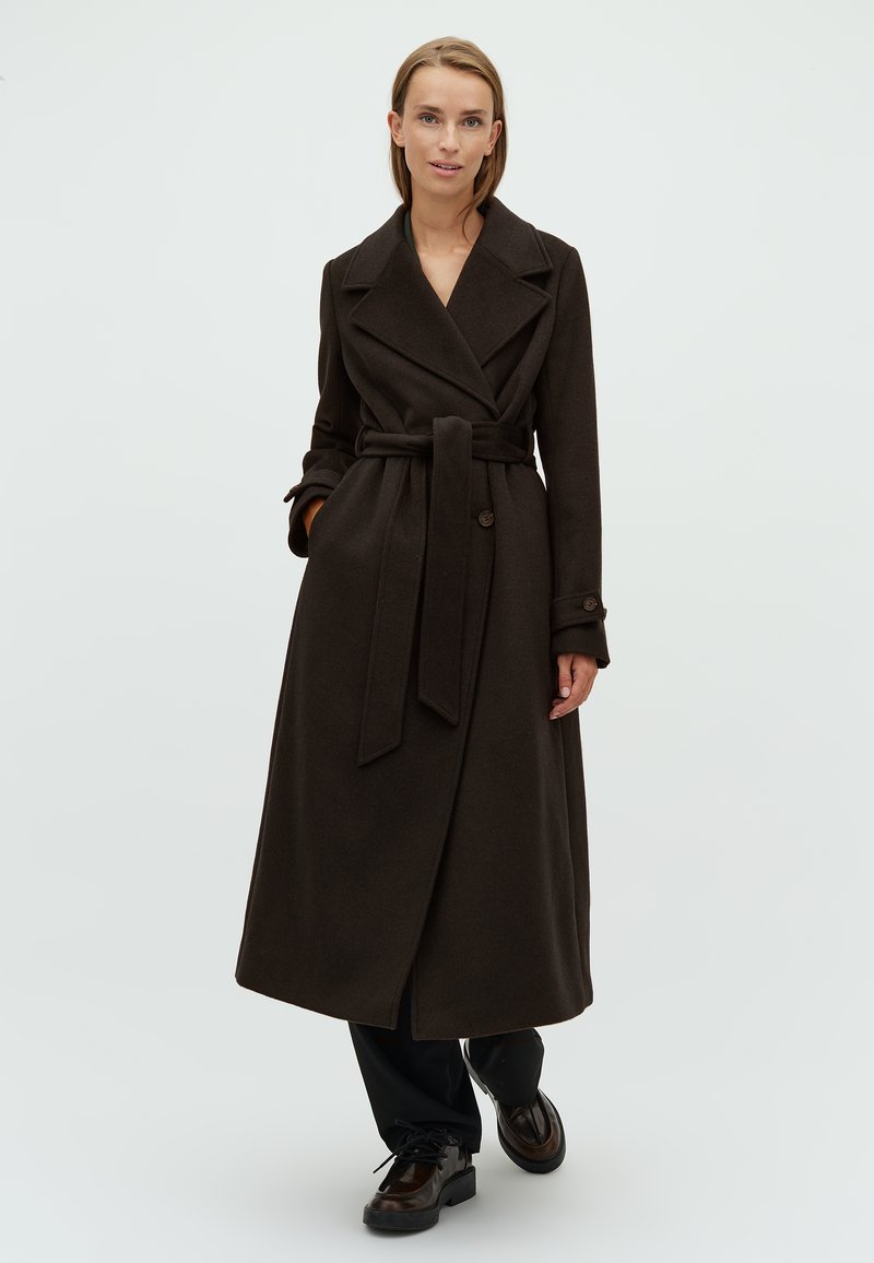 Long brown wool coat with a belted waist, wide lapels, and buttoned cuffs. Features a streamlined silhouette and soft texture.