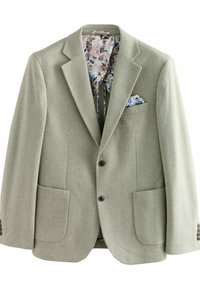 Hellgrünes Blazer mit zwei vorderen Taschen und braunen Knöpfen. Blumenmuster-Futter sichtbar am Kragen und in der Taschentuchtasche. Strukturierten Stoff.