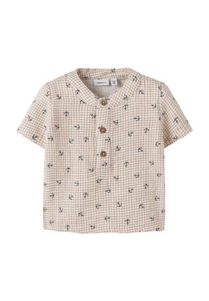 Maglietta beige per bambino piccolo con maniche corte, motivo a griglia marrone, piccole ancore blu navy, tre bottoni di legno sulla patta frontale, collo rotondo.