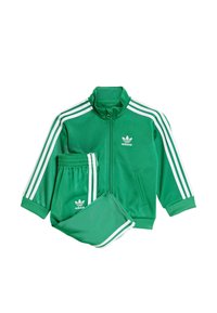 Zielony dres składający się z kurtki na zamek z białymi paskami i logo oraz dopasowanych spodni. Wykonany z gładkiego, lekkiego materiału.