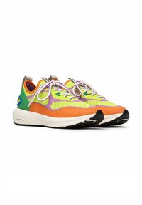 Colorful sneaker featuring mesh upper in yellow, purple, and green, with an orange midsole and black rubber outsole. Accented with white laces.