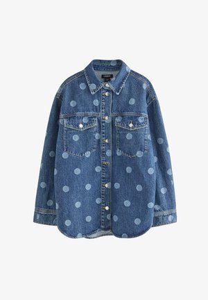 Camicia di denim con pois blu, maniche lunghe, colletto a punta, due tasche sul petto e bottoni a pressione. Tessuto morbido con vestibilità comoda.