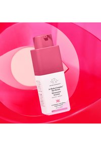 Pink bottle of A-Shaba Complex Eye Serum with a matte finish, featuring white label text and a pump top, set against a bright pink background.