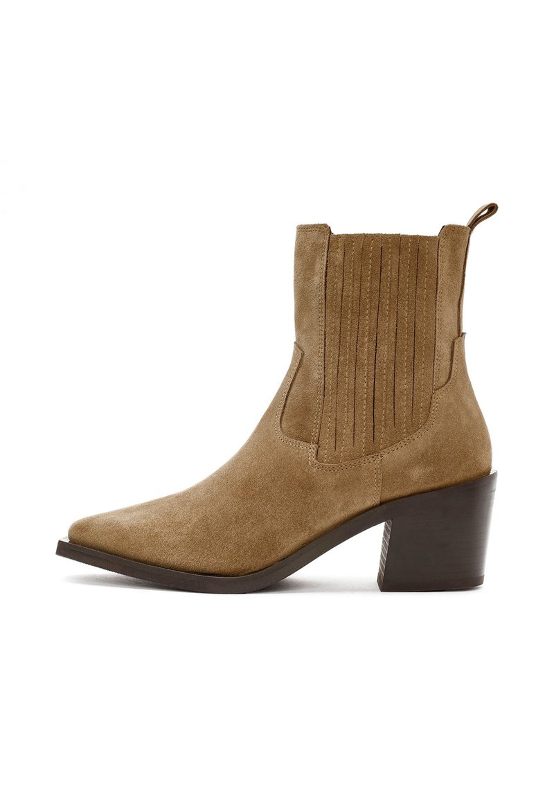 Brown suede ankle boot with pointed toe, vertical seam detailing on shaft, and a sturdy block heel. Features a pull tab for easy wear.