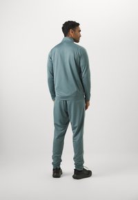 Under Armour RIVAL KNIT - Tracksuit - jasper blue/serpentine