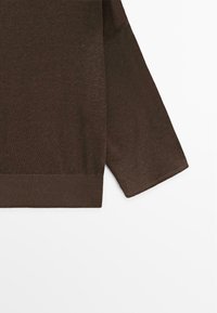 Brown long-sleeve knit sweater with ribbed hem and cuffs, displayed against a white background.