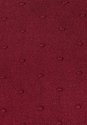 Bordeaux sok met een textuurpatroon van kleine, verhoogde stippen. Gemaakt van een gebreid materiaal dat een zachte afwerking biedt.