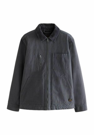 Graue Jacke mit Cordkragen, Frontreißverschluss und zwei aufgesetzten Taschen. Verfügt über eine Brusttasche mit Reißverschluss, die ein utilitaristisches Design schafft.