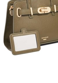 Olivengroene handtas van textuurleer, met gouden hardware, een sluiting met sluitmechanisme en een afneembare ID-tag met een lege oppervlakte.