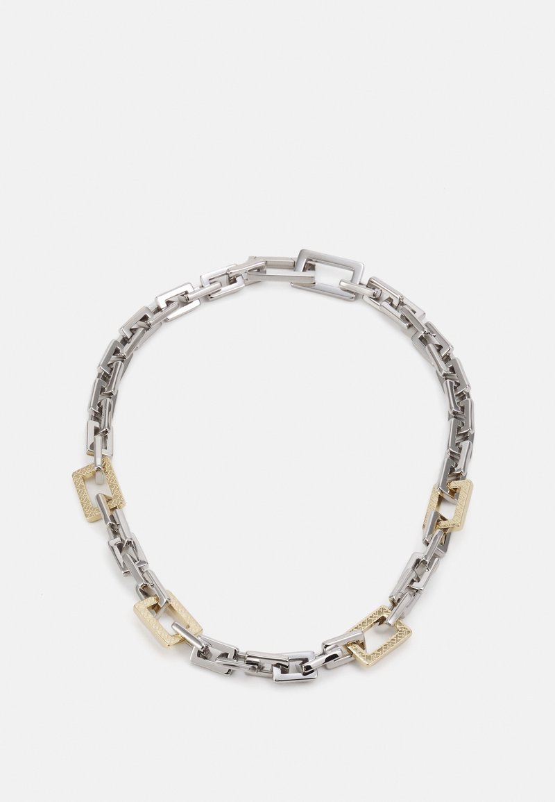 Collier chaîne en argent avec des maillons rectangulaires en or alternant entre lisse et texturé, sur fond blanc.