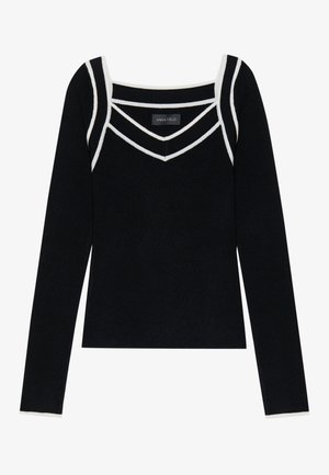 Musta pitkähihaisessa paidassa on nelikulmainen pääntie, jossa on valkoista kontrastivärityötä kaulan ja hartioiden alueella. Tämä vaate on valmistettu pehmeästä, teksturoidusta kankaasta.