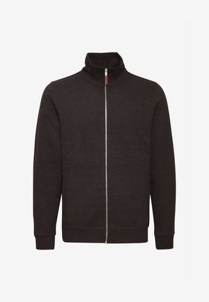 Mørkebrun hettejakke med glidelås og høy krage, to sidelommer, samt ribbestrikkede mansjetter og kant. Laget av et mykt, strukturert stoff.