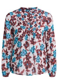 Blouse fleurie avec un col rond, ornée de fleurs rouges et bleues sur un fond blanc. Manches longues et légère fronce au niveau de la poitrine.