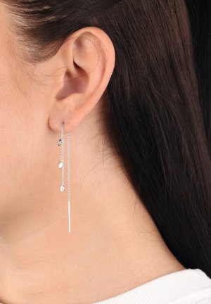 Silberne Tropfohrringe bestehen aus langen Ketten, an denen kleine Blatt- und ovalförmige Elemente hängen, die elegant neben dem Ohr baumeln.