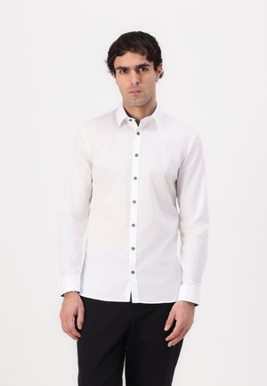 White long-sleeve shirt with a fitted design, featuring a button-down collar, black buttons, and a smooth fabric texture.