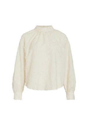 Blusa color crema realizzata in tessuto morbido e peloso, con collo alto e maniche lunghe con dettagli arricciati sui polsini.