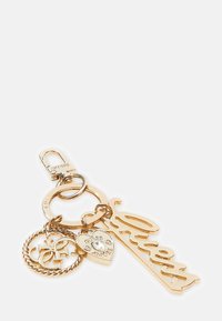 Gold-tone Guess keychain with a logo ring, heart charm engraved "Guess Amore" with a crystal, and a scripted "Guess" tag.