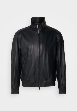 Black leather jacket with a stand-up collar, zip closure, and ribbed cuffs. Smooth texture and sleek design with side pockets.