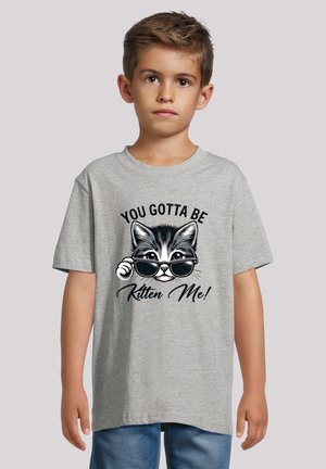 Gray t-shirt featuring a cartoon cat wearing sunglasses with the text "YOU GOTTA BE KITTEN ME!" in black, casual short-sleeve design.