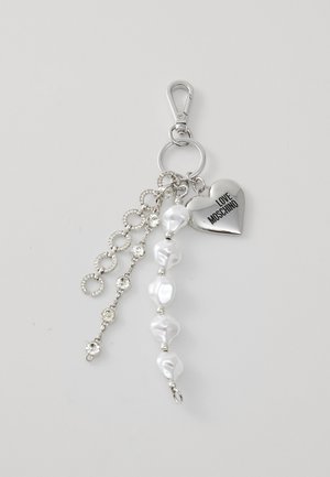 Silver keychain featuring a heart charm inscribed "LOVE MOSCHINO," irregular white beads, and a chain with circular links and rhinestones.