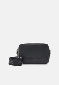 Black leather crossbody bag with embossed "VALENTINO" logo, rectangular shape, silver hardware, and a patterned black strap.