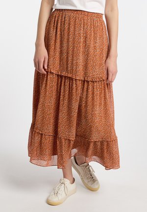 Lagts midi nederdel i rust orange med små hvide blomsterprint. Fremstillet af letvægtsstof, har elastisk talje og volanger i kanten.
