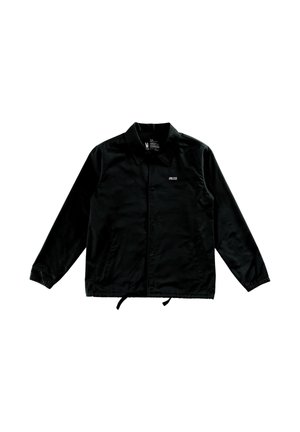 Zwarte blouse met knopen, kraag, elastische manchetten, trekkoord in de zoom en kleine witte tekst "UNLESS" op de linkerborst.