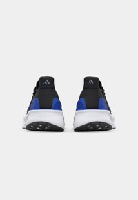 Black athletic shoes with blue accents, textured upper, and a white cushioned midsole, featuring a patterned rubber outsole and logo detail.