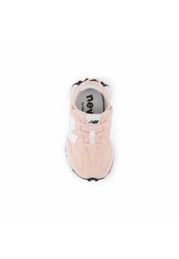 Pink athletic shoe with a mesh upper, white accents, and black sole. Features curved design and laces. Logo visible on the insole.