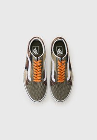 Scarpe da ginnastica in tela con motivo camouflage, caratterizzate da lacci arancioni, dettagli bianchi e una fodera interna nera. Punta arrotondata e suola piatta in gomma.