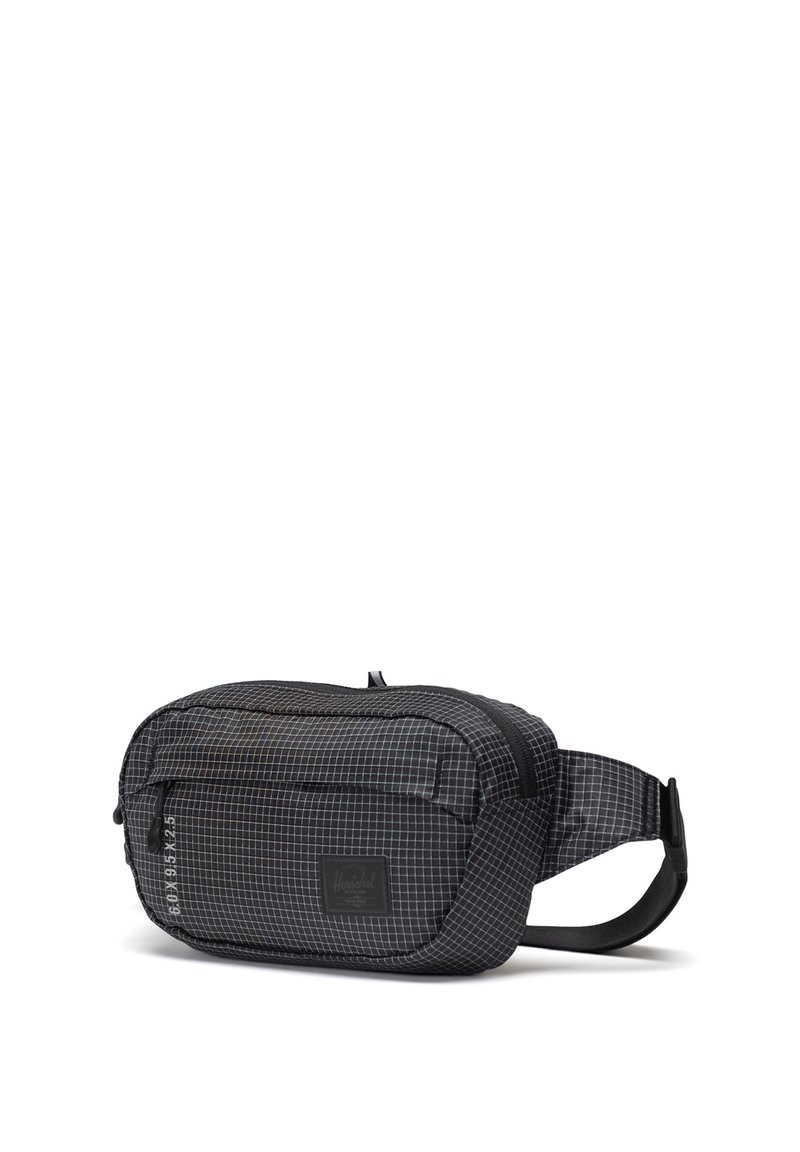 Black fabric waist bag with a grid pattern, zippered compartments, adjustable strap, and a brand label on the front. Textured surface.