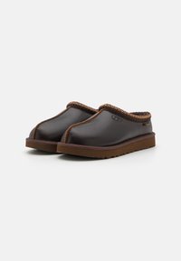 Brown leather slip-on clogs with a rounded toe, brown stitching accent, and a brown rubber sole. Soft textured lining visible at the opening.