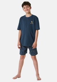 Navy cotton T-shirt and shorts set, featuring yellow palm tree patterns. The T-shirt has a simple crew neck and relaxed fit.