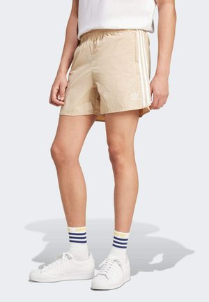 Beige lightweight shorts with an elastic waistband, featuring three white stripes along the sides and a small white logo on the front.