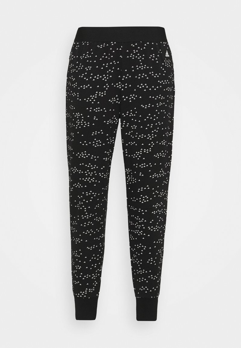 Sorte sweatpants med et gentagende hvidt geometrisk mønster, med elastisk talje og manchetter. Fremstillet af et blødt, strækbart stof.