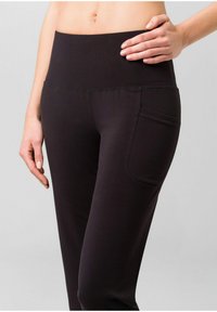 Hoch taillierte schwarze Leggings aus dehnbarem Stoff mit glatter Textur und einer Seitentasche für die Aufbewahrung.
