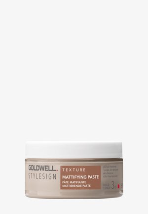 Goldwell Stylesign Texture matterende pasta in een klein rond bakje met witte deksel, ontworpen voor alle haartypes, houdniveau 3 van 5.