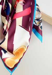 Silk scarf in deep burgundy with abstract patterns in pink, cream, and blue. Edges trimmed in bright blue, with a smooth texture.