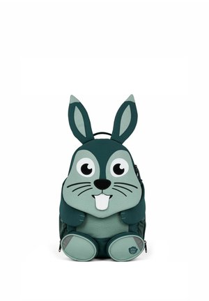 Children's backpack shaped and designed like a green cartoon rabbit with large eyes, ears, a nose, whiskers, and two front teeth.