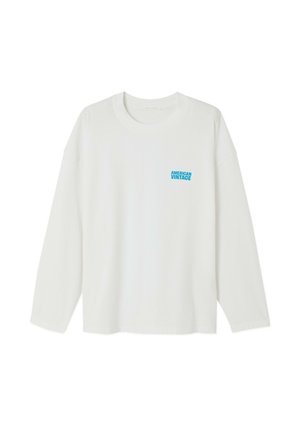 Bela majica z dolgimi rokavi iz bombaža. Ima okrogli izrez in majhen modri napis "AMERICAN VINTAGE" na levi strani prsnega koša.
