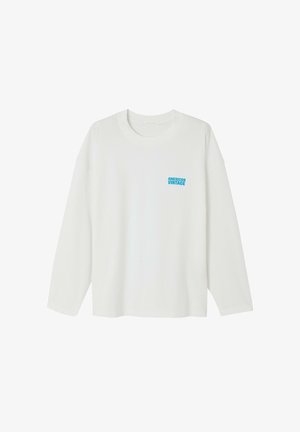 Valge pikamaoline särk, mis on valmistatud puuvillast. Omab ümmargust kaelust ja vasakul rinnakohal väikest sinist "AMERICAN VINTAGE" logo.