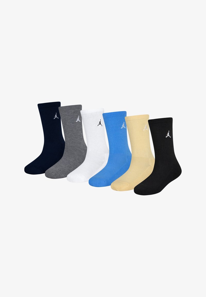 Conjunto de siete calcetines en varios colores: marino, gris, blanco, azul, amarillo y negro. Presenta una textura acanalada y un pequeño logotipo en cada uno.