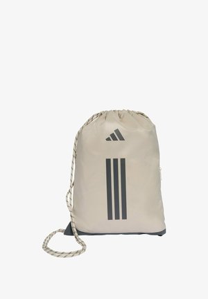 Beige drawstring gym bag made of durable fabric, featuring three dark stripes and a logo, with a textured strap and a zippered pocket.