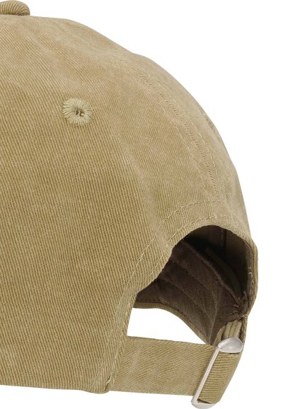 Cotton baseball cap in light brown with textured ridges, adjustable strap, and metal hardware at the back. Six-panel construction.