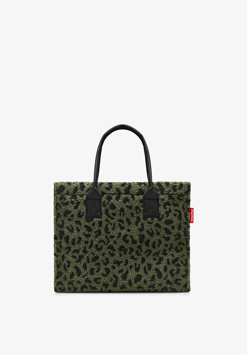 Green faux fur tote bag with black leopard spots, flat design, dual black handles, and a red logo tag on the side.